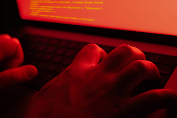 A hacker infiltrates a remote network on a laptop